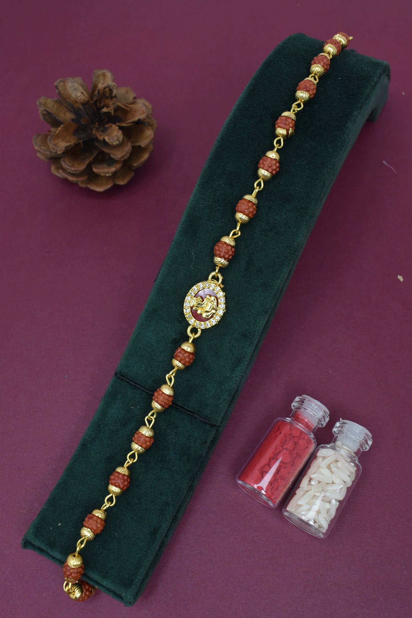 Goldplated AD studded Ganesh With Rudraksh Bracelet Rakhi