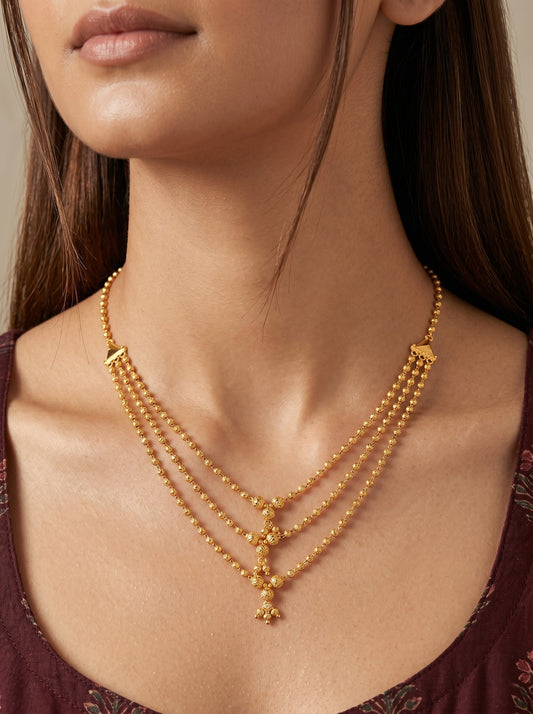 Traditional Gold-Toned Layered Beaded Ethnic Necklace with Dangling Charm Details for Women