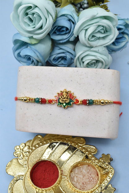 Elegant Lord Ganesh with Green n Red Lotus  Gold plated Antique rakhisSet of 2 Rakhi  Made from Cotton Threds with Pack of Roli Chawal n Rakshabandhan Greetings Card |rakhi for brother|Bhaiya Rakhi | Kids rakhi |Rakhi for kids|Rakhi for Bhaiya