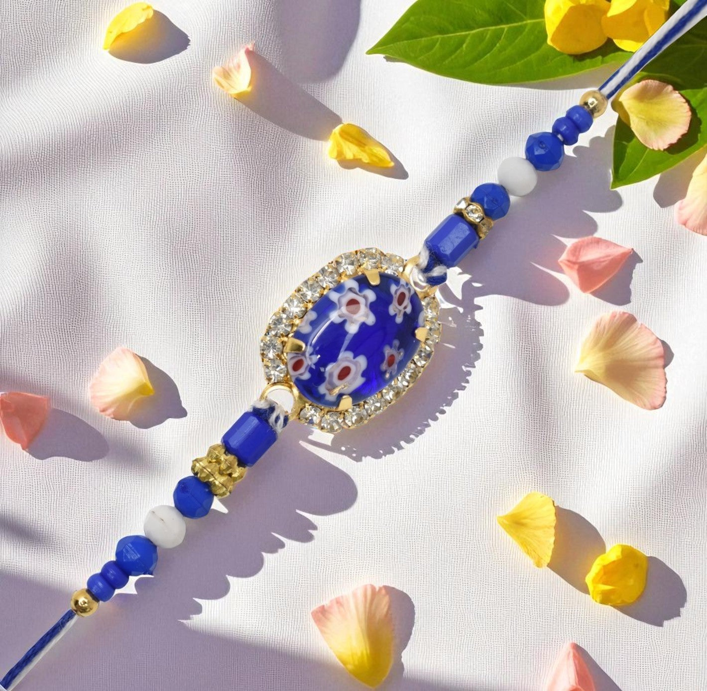 Resin Style AD Studded Heavy Designer Rollstone Blue Rakhi