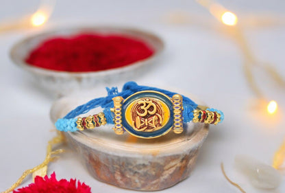 Spiritual OM with Damru Aesthtic Rakhis  Divine Goldplated  Multicolored  Rakhis 1 Rakhi Made from Cotton Threds with Pack of Roli Chawal n Rakshabandhan Greetings Card |rakhi for brother|Bhaiya Rakhi | Kids rakhi |Rakhi for kids|Rakhi for Bhaiya